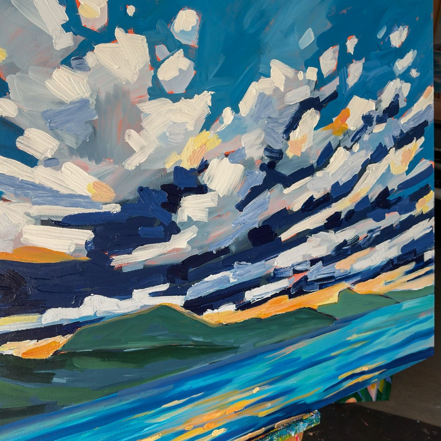 Painting of a landscape with blue sky and green mountains